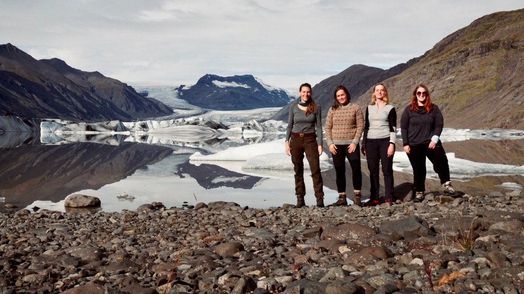 Photo of the members by a glacier
